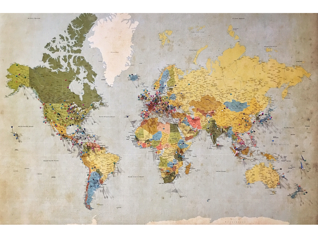 World map with colored pins marking various locations across continents.